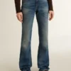 Blugi pentru femei cu croială bootcut, spălare vintage și detalii metalice
